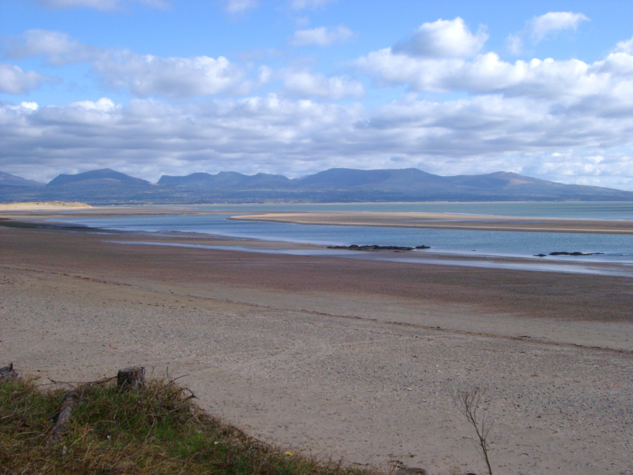 an image of Beautiful Tranquil Panorama View from Famous Snowdonia at National Parks in Wales on a Cloudy Sky Above.