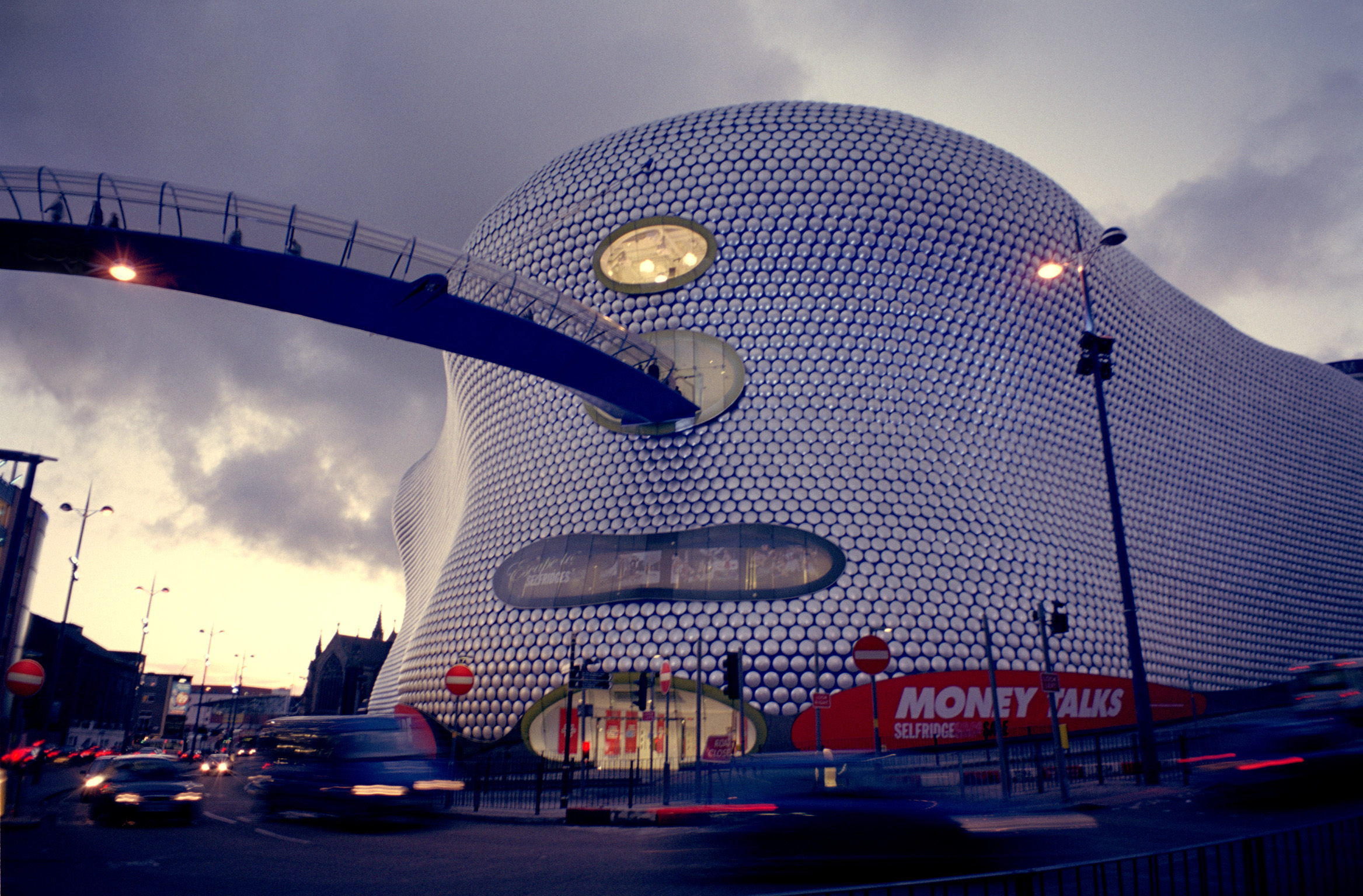 an image of Street Scene Along Famous Bullring Shopping Center, Located at Birmingham, England During Night Time.
