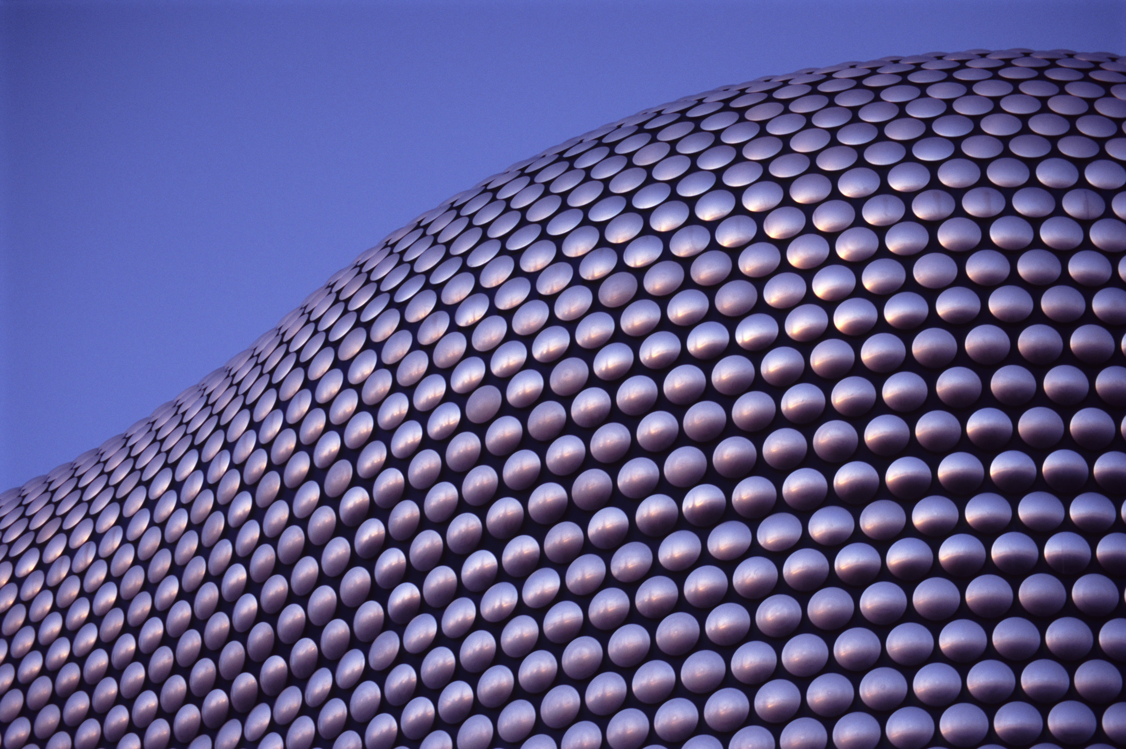an image of Close up on the cladding of the Selfridges Building at Birmingham Bullring Shopping Center on a Sunny Day with Blue Gray Sky Background.