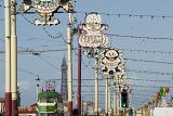 a view down blackpool promenade, illuminations, a tram and blackpool tower