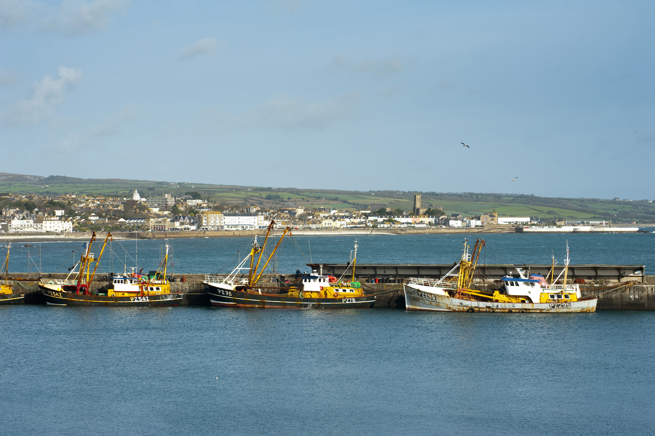 an image of Looking out across newlyn harbour towards the town of penzance, cornwall