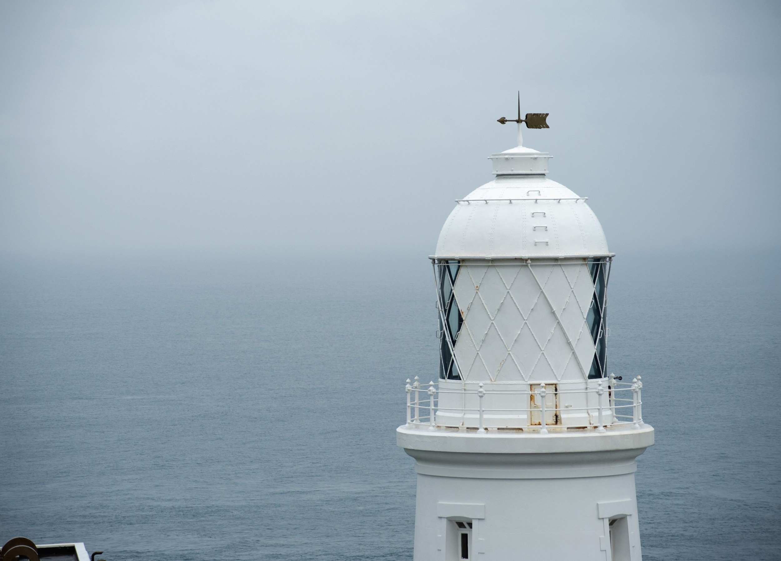 an image of a foggy day looking out to sea at the pendeen lighthouse, cornwall