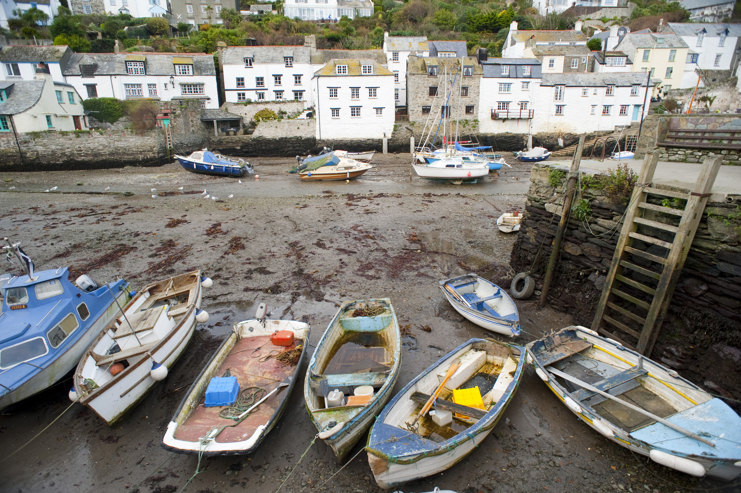 an image of boats at low tide in polperro harbour
