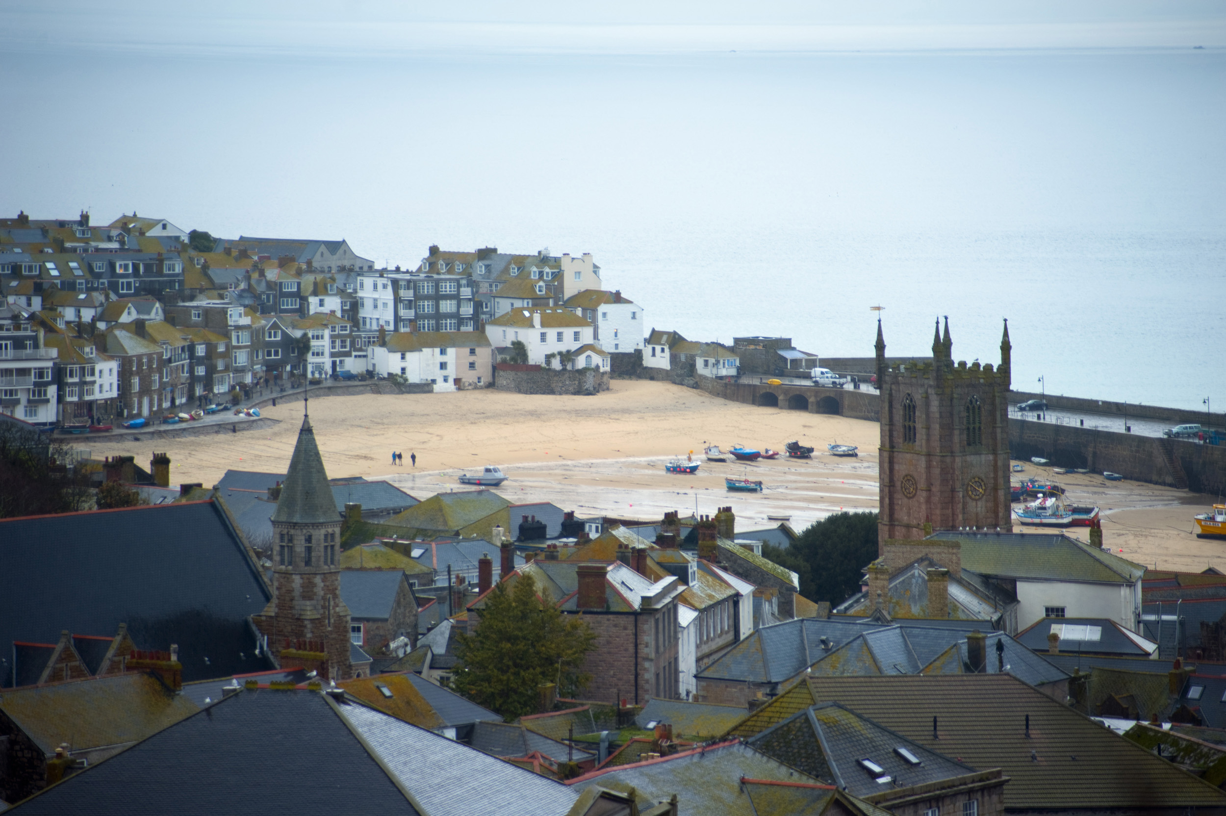 an image of a telephoto view looking down over the rooftops of st ives, cornwall