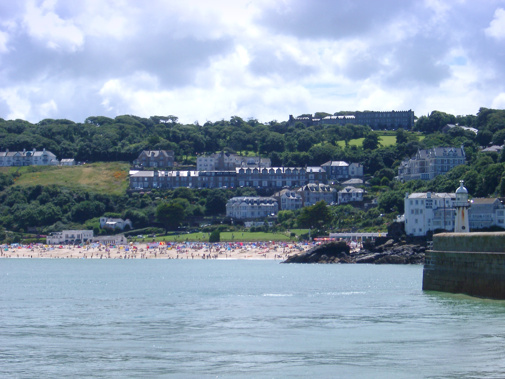 an image of beach and harbour wall at st ives, cornwall