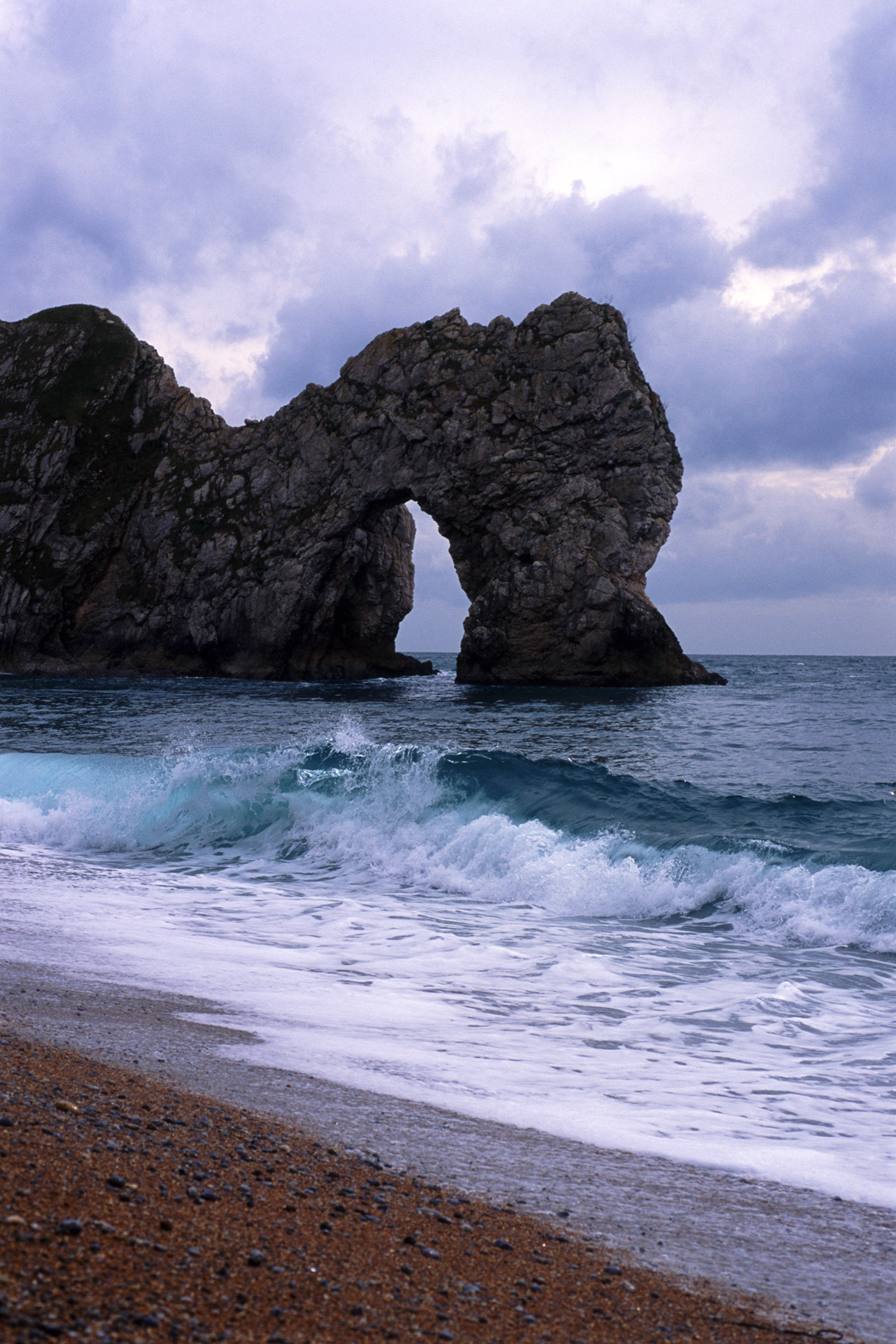 an image of The famous Durdle Door stone arch eroded by the sea from the Jurassic coastline, dorset