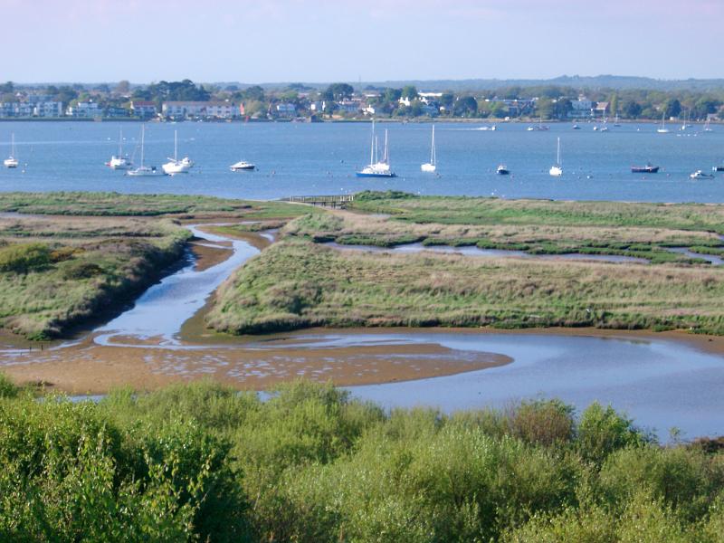 estuary with moored boats around christchurch, dorset