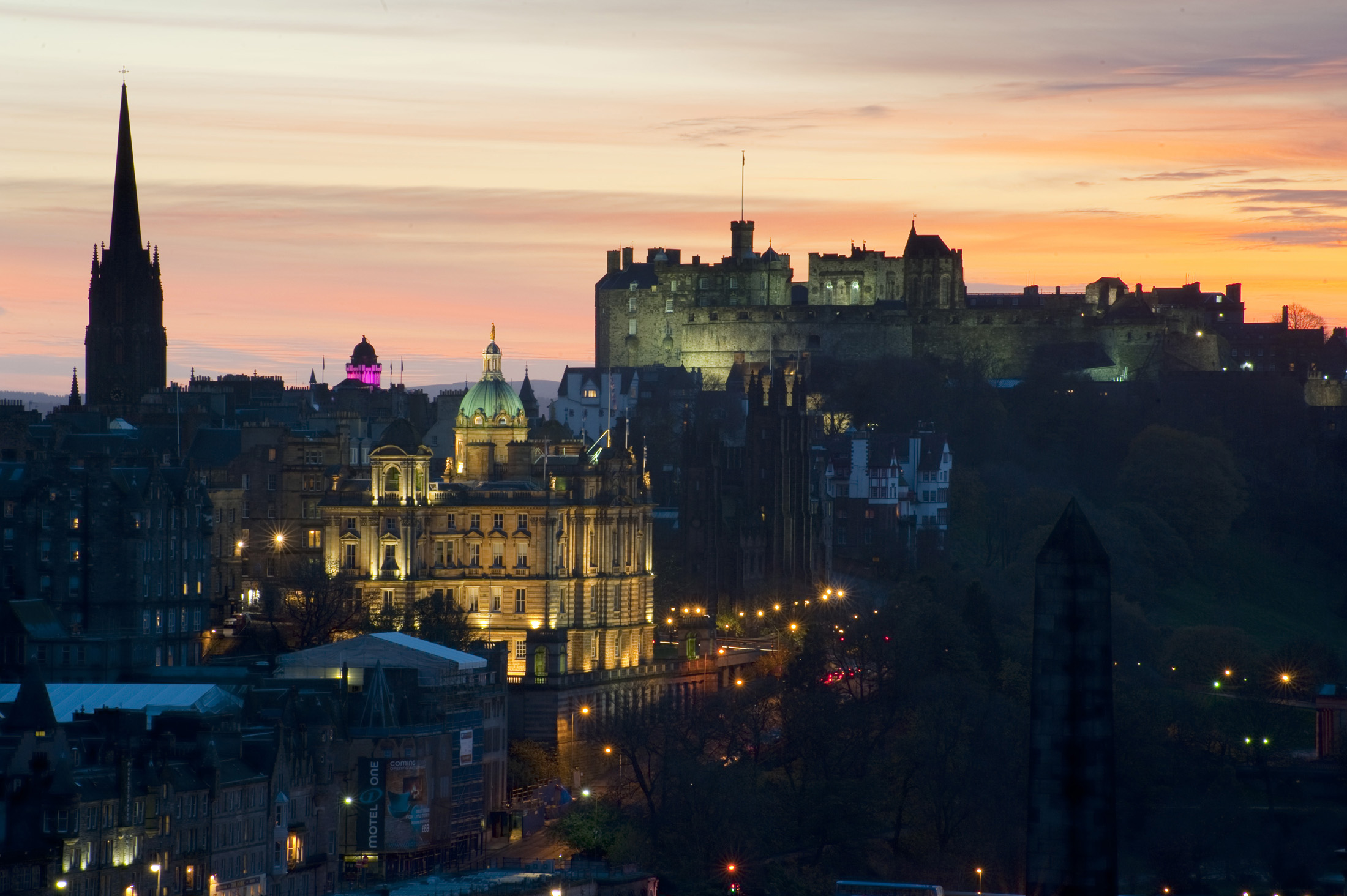 an image of Floodlit at night, edinburgh castle, the camera obscura (pink) and other landmarks in the so called Athens of the north