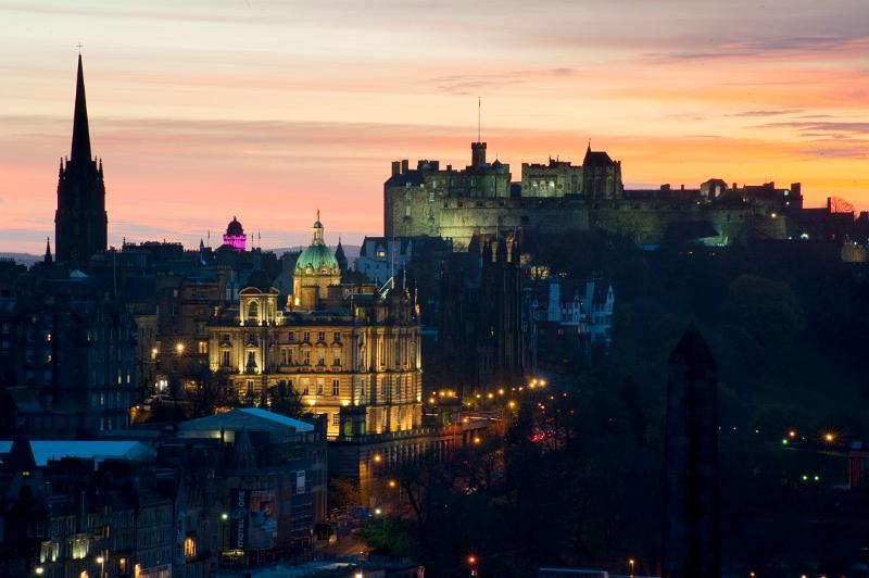 Floodlit at night, edinburgh castle, the camera obscura (pink) and other landmarks in the so called Athens of the north