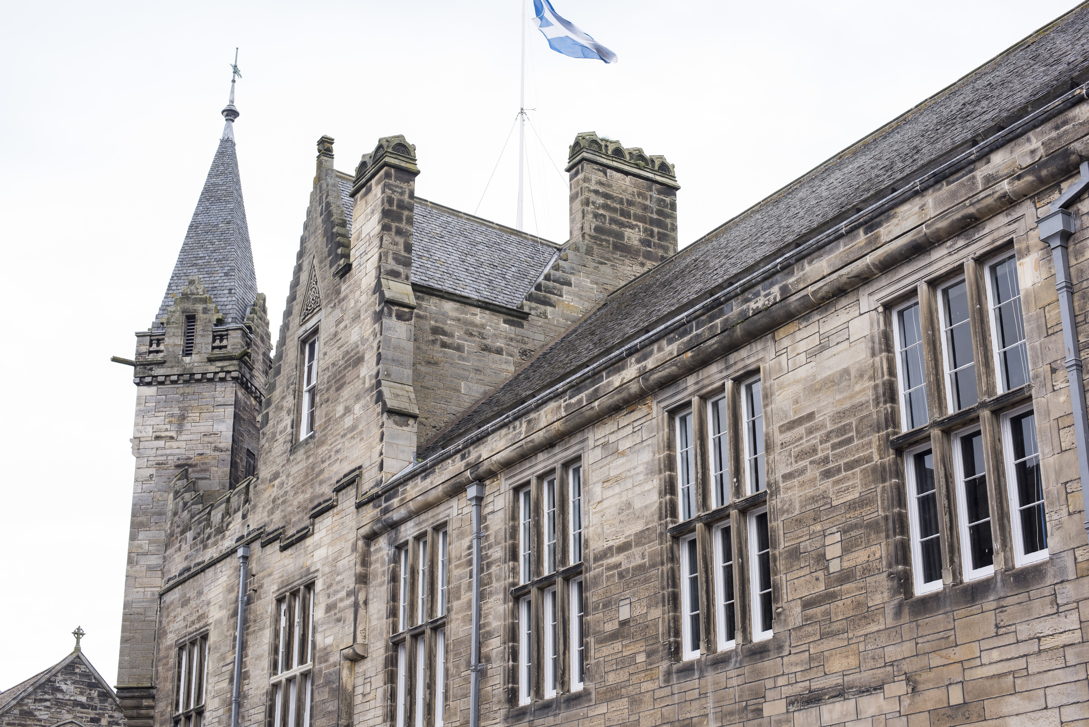 an image of Close up of second floor of town hall with flag waving at top in Saint Andrews, Scotland