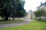 Paved asphalt winding walkway leading to little corner section of University of Saint Andrews in Scotland