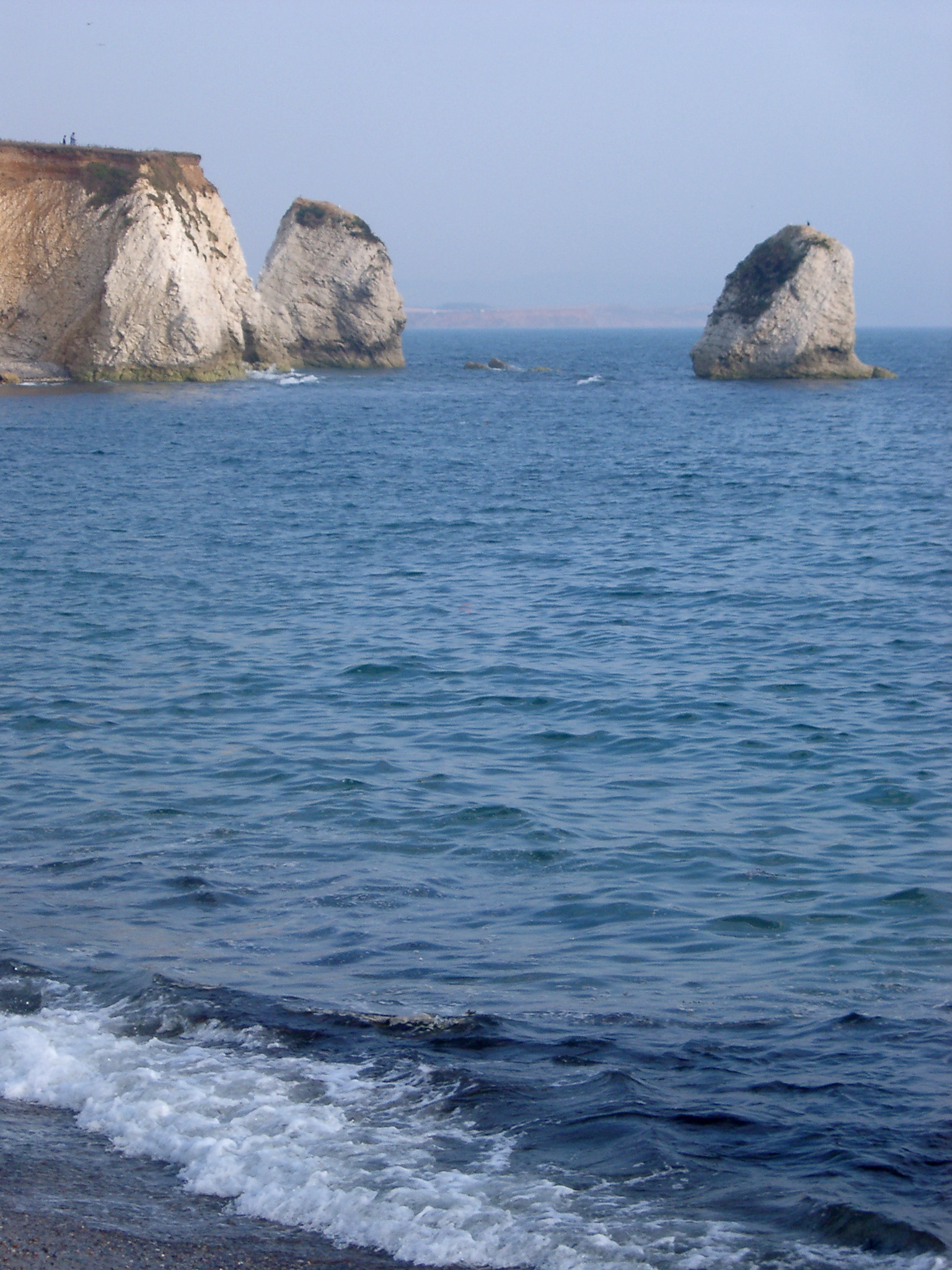 an image of View of the line of chalk Needles, Isle of Wight, consisting of eroded chalk stacks rising directly from the ocean