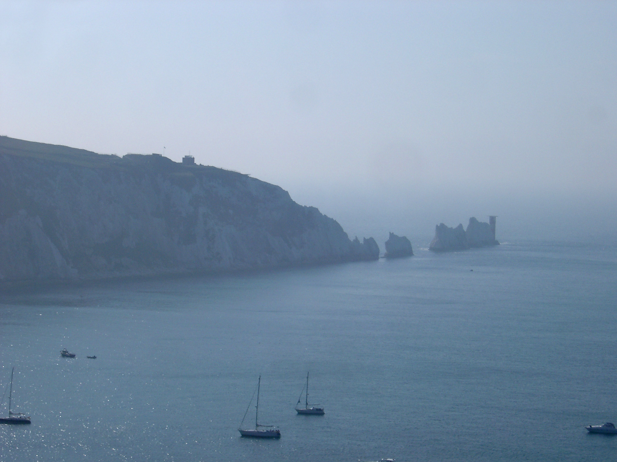 an image of The Needles, Isle of White, a line of chalk stacks rising from the ocean just offshore from the headland