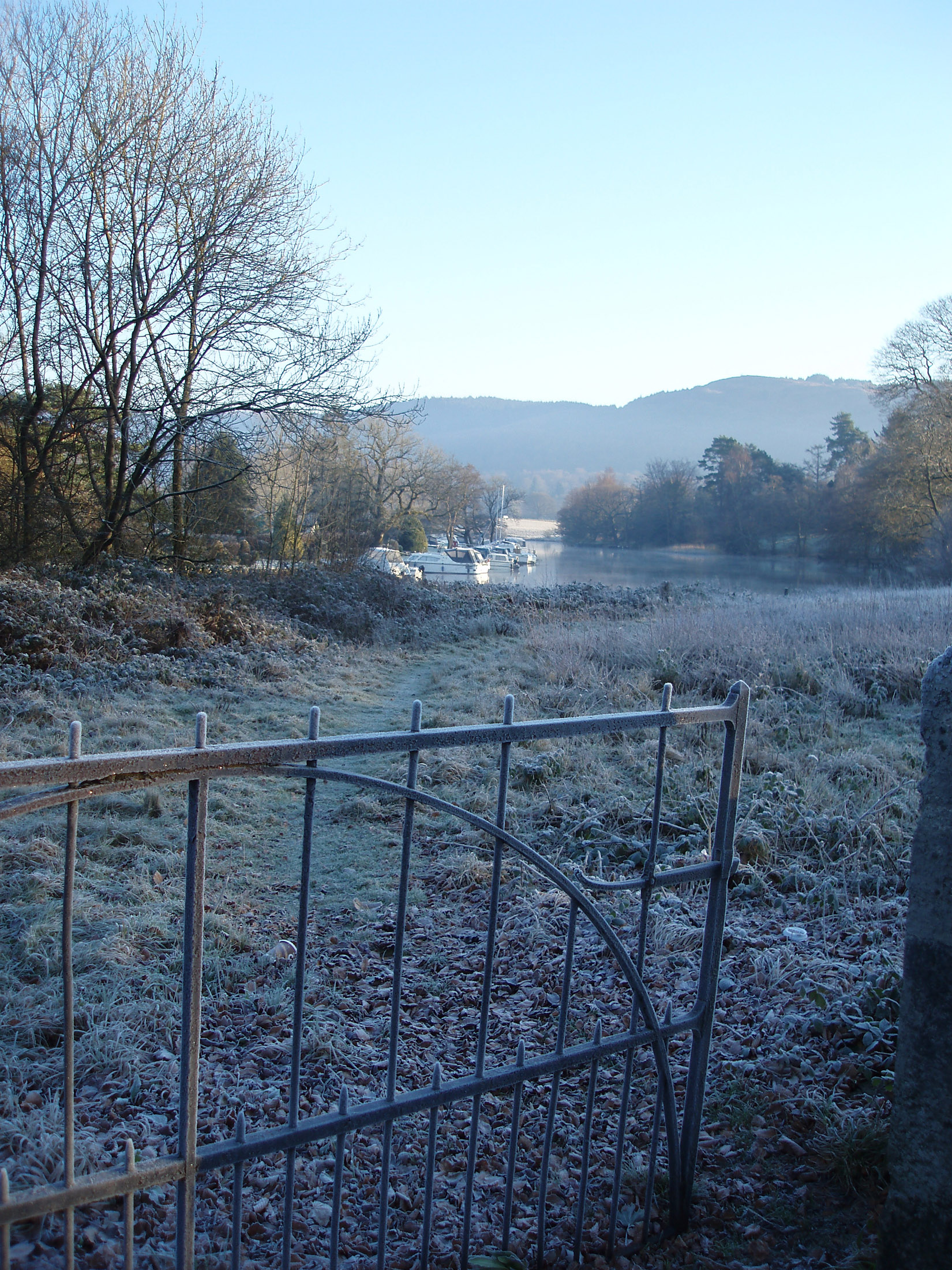 an image of frosty winter morning at newby bridge looking out across the end of windermere