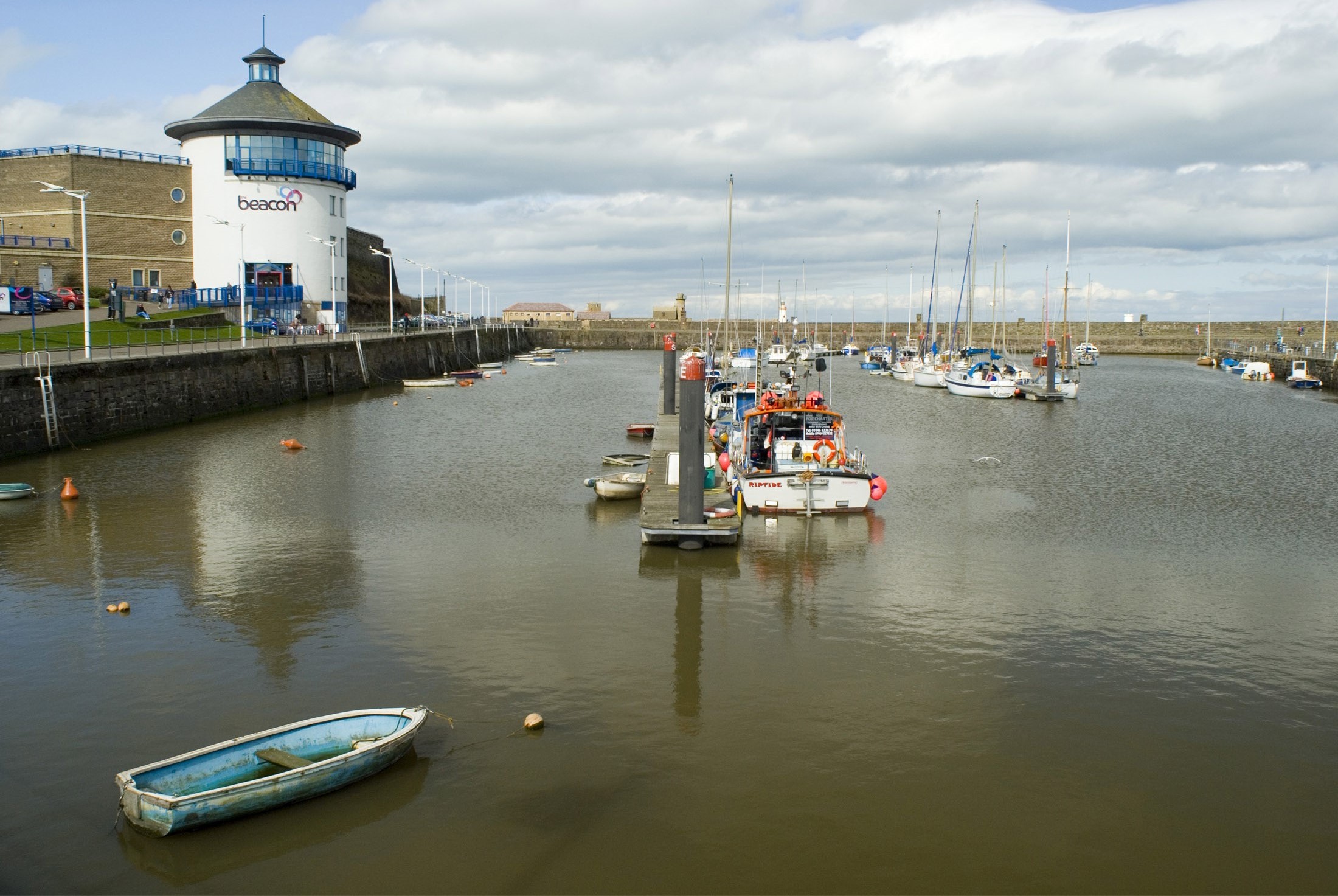 an image of boats in the harbour and the beacon museum