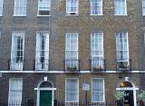 Georgian terraced houses with their tall elegant sash windows and arched entrances in London, UK