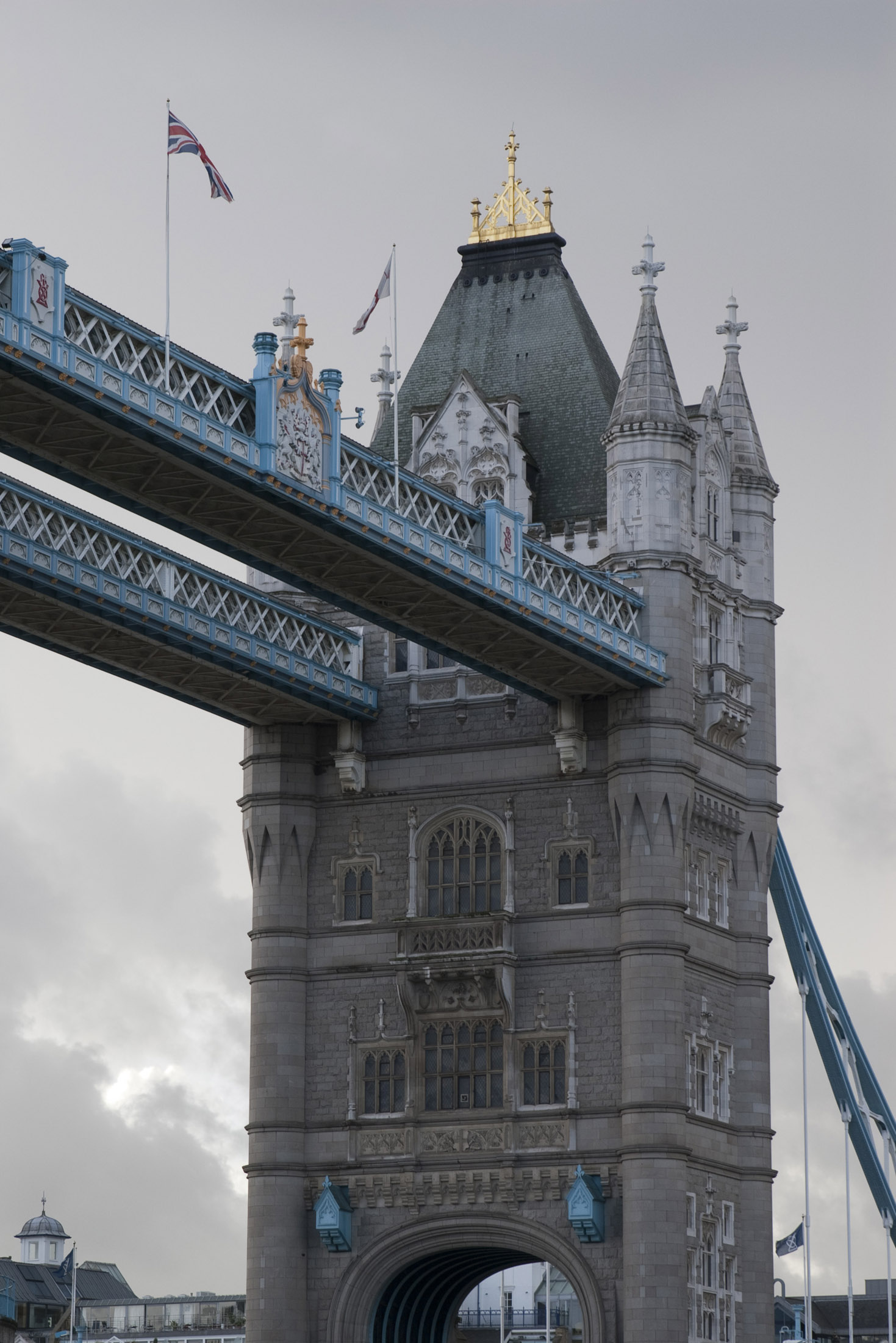 an image of close up on one of the towers on london tower bridge showing the victorian gothic architectural style of the stone cladding