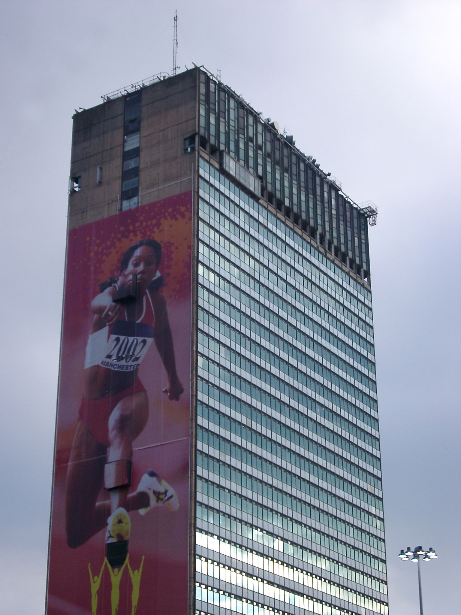 an image of Architectural Detail of Sunley or City Tower with Sports Advertisement, Manchester, England