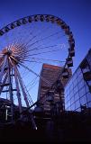 The Manchester Wheel - Famous Transportable Ferris wheel Installation at Piccadilly Gardens, Manchester, England. Captured at Night Time.