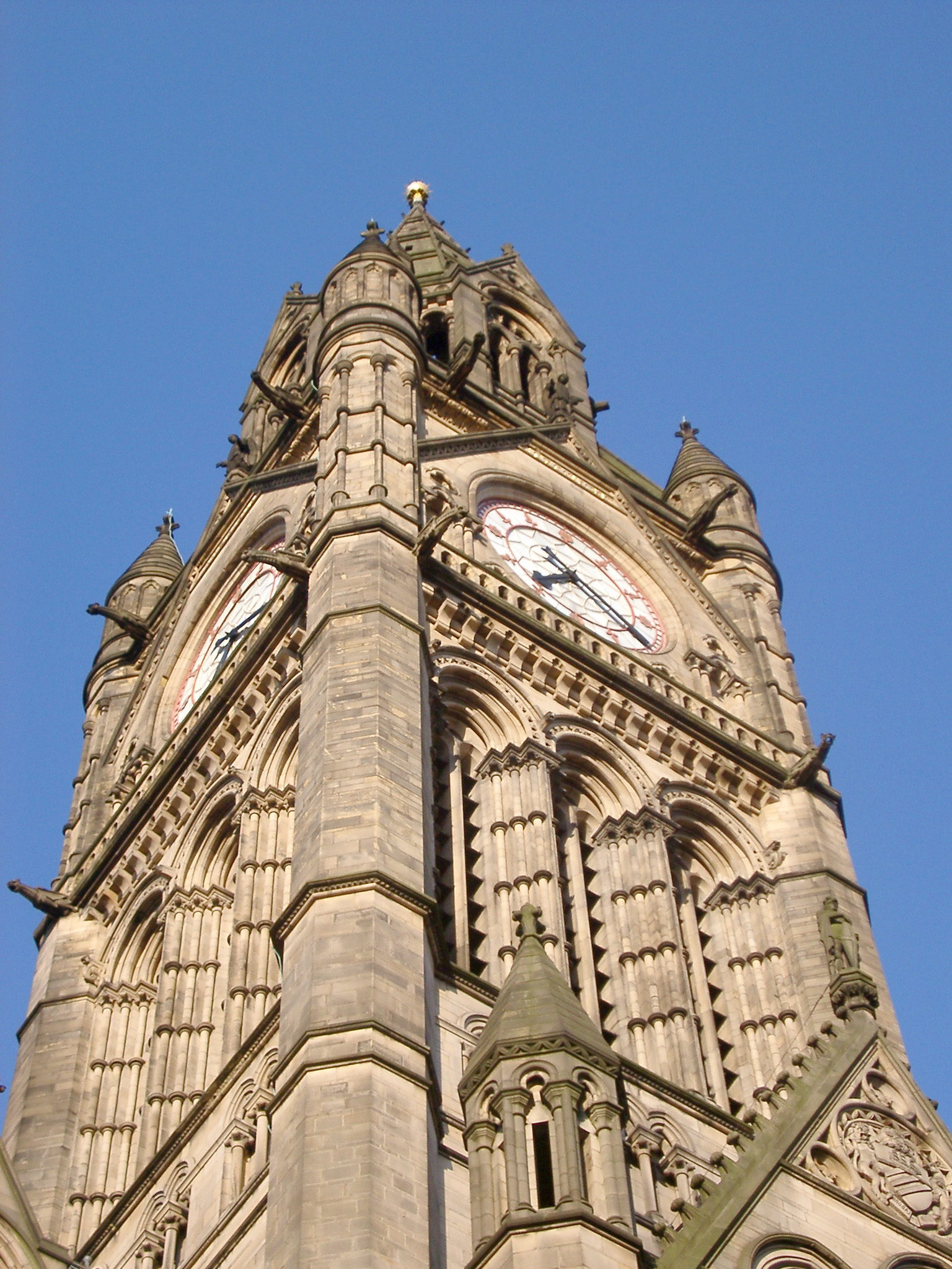 an image of View looking up at the ornate stone Gothic revival architecture of the Manchester Town Hall clock tower
