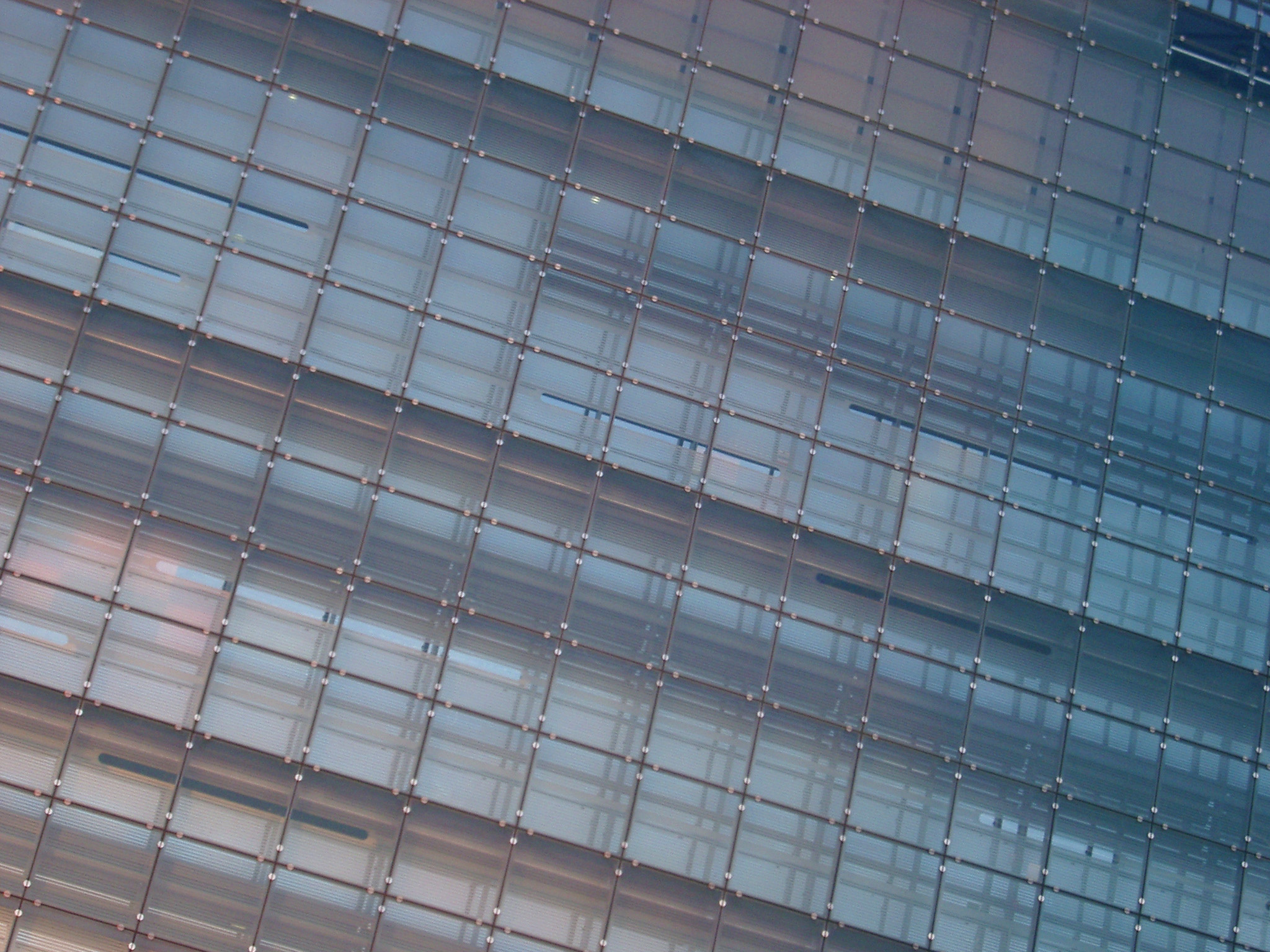 an image of Oblique architectural close-up of the glass facade of a modern urban building