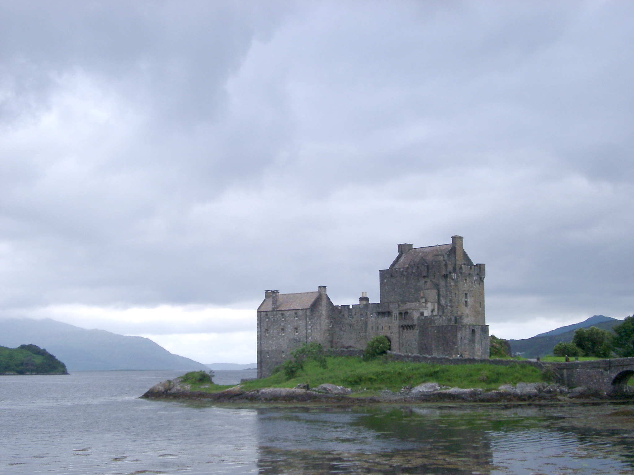 an image of Eilean Donan Castle, tourist attraction, built on a small tidal island in western Highlands of Scotland