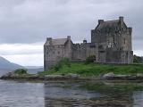 Eilean Donan Castle, Scotland standing on its island in the centre of Loch Duich on a calm cloudy day