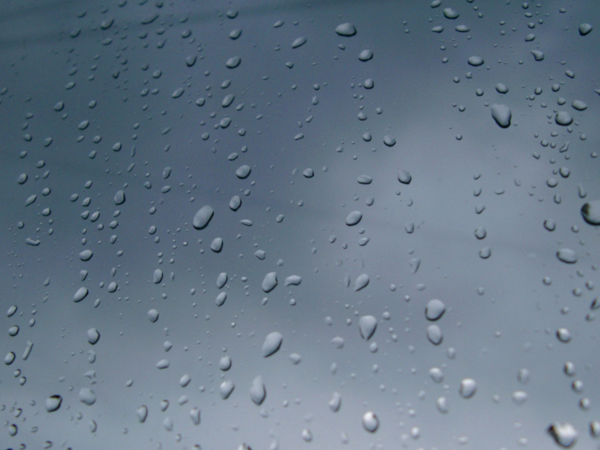an image of Close up Shot of Conceptual Rain Drops on Glass Window. Can be Used for Wallpaper Backgrounds.