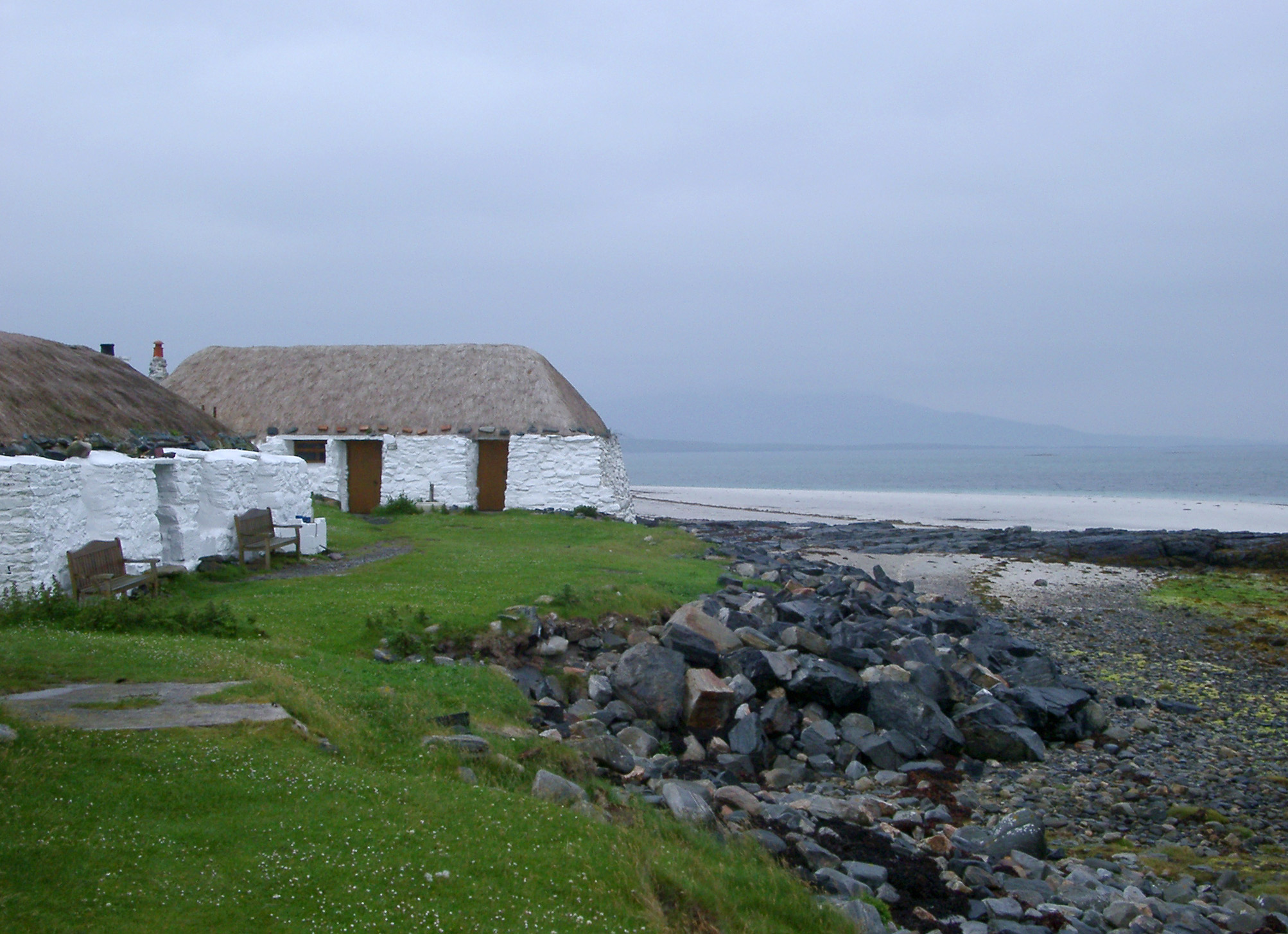 an image of Rustic thatched white house with rough plastered walls in the Hebridies Western Isles used as a hostel