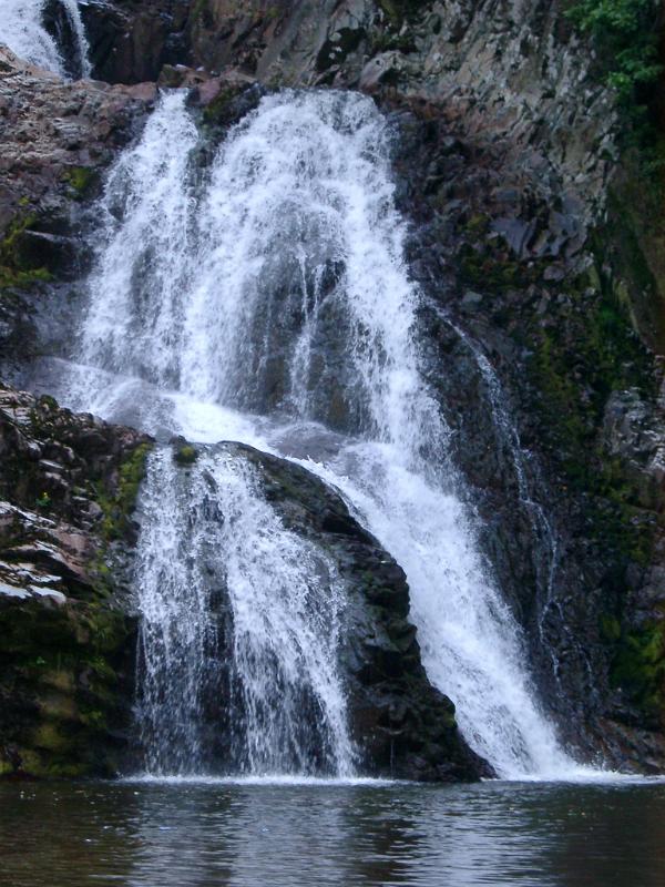 Spectacular Rhaeadr Mawddach waterfall with cold water flowing over the steep rock into the river, in Wales, UK, Europe