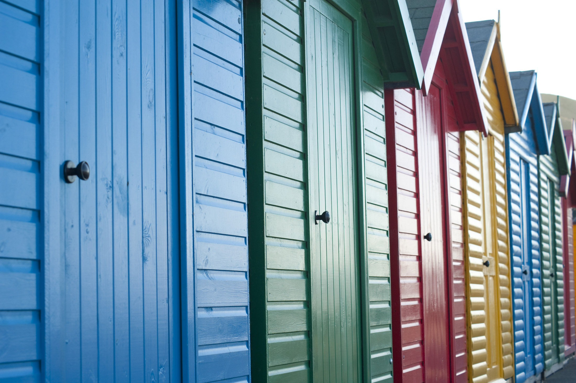 an image of beach huts on the shore at whitbys west cliff