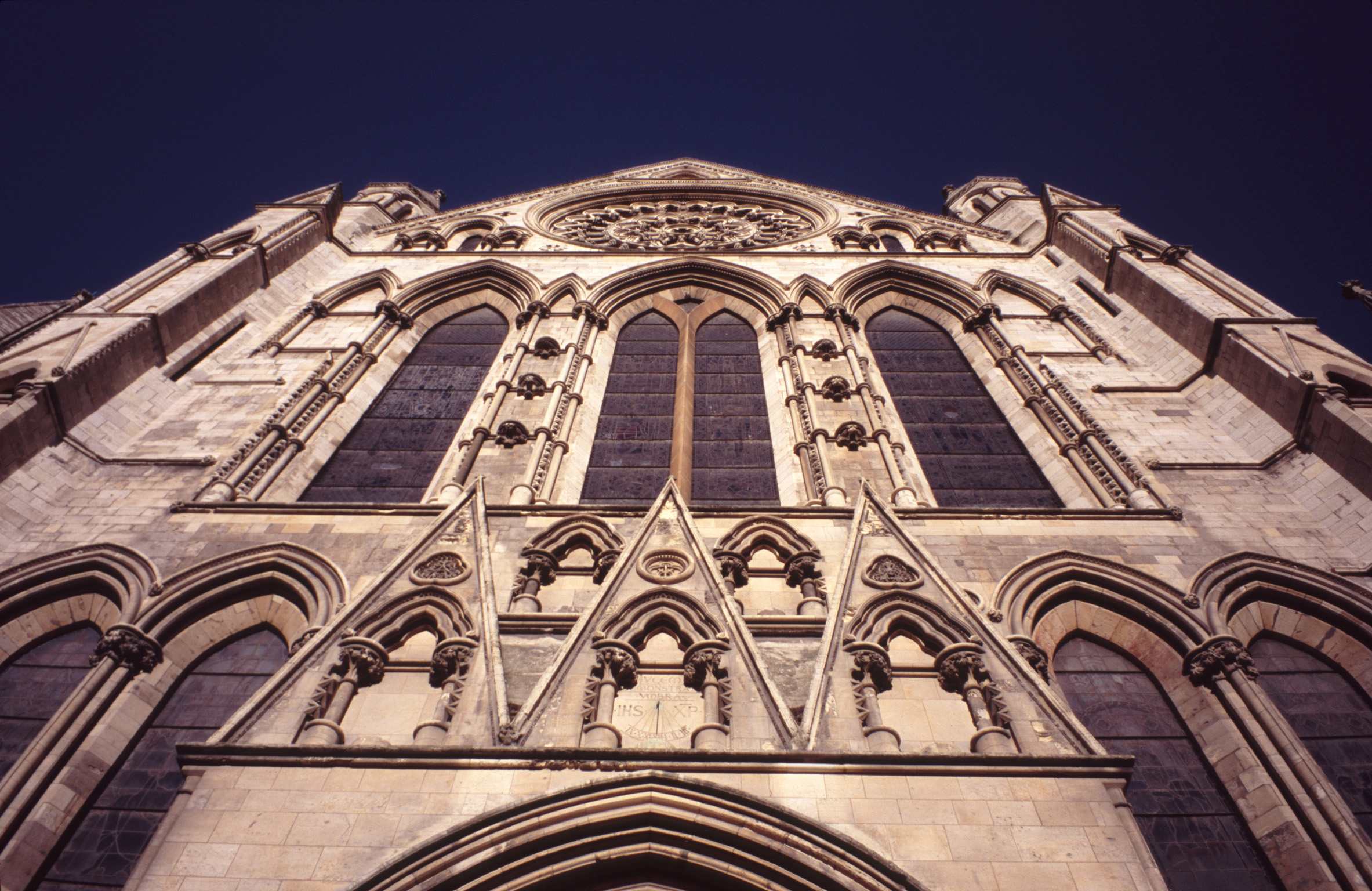 an image of Looking up at the arched windows on the stone exterior facade of York Minster Cathedral, York, UK