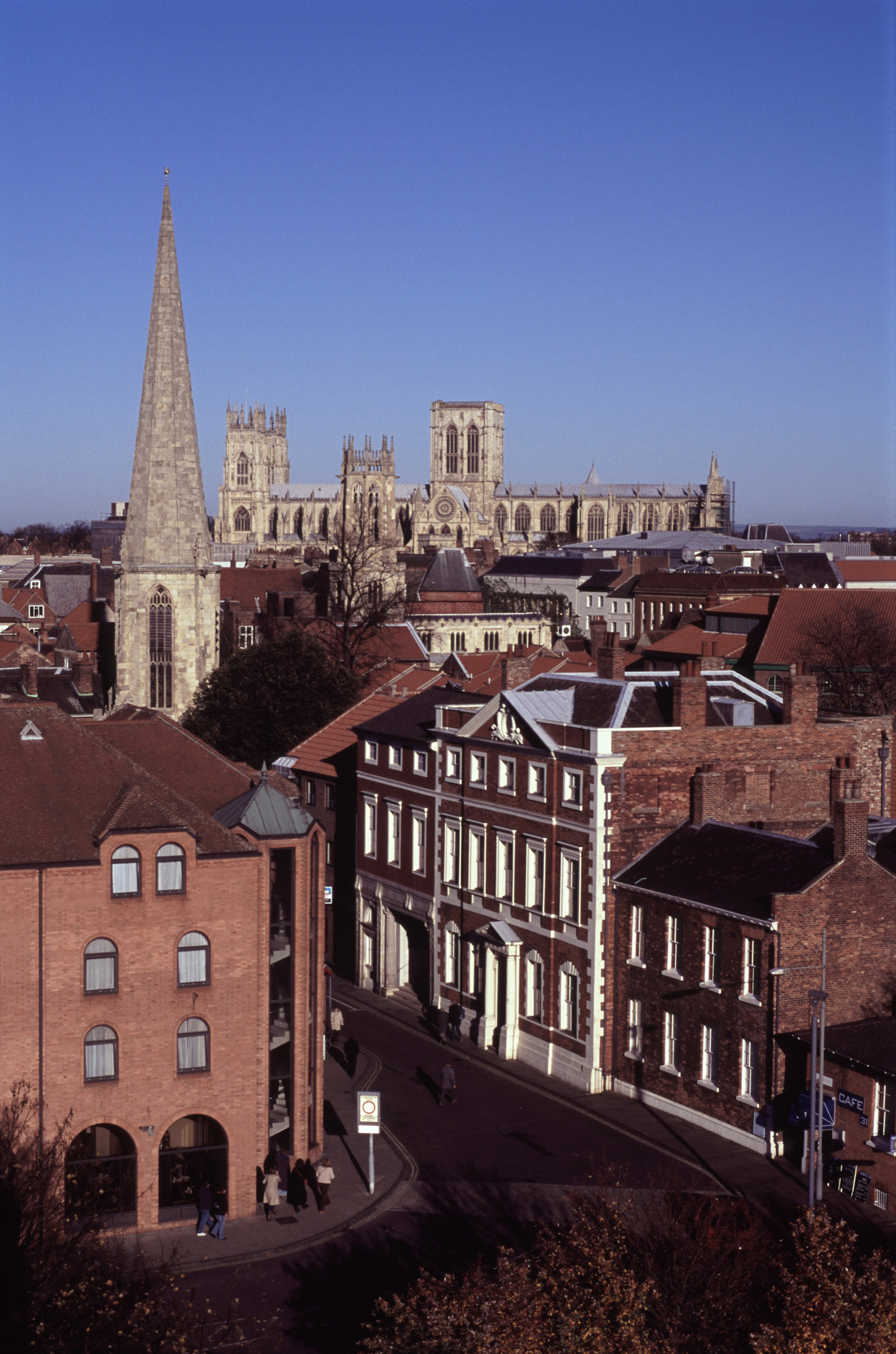 an image of Aerial View of Historic Buildings and Streets at York, England. Captured with Light Blue Sky Background.
