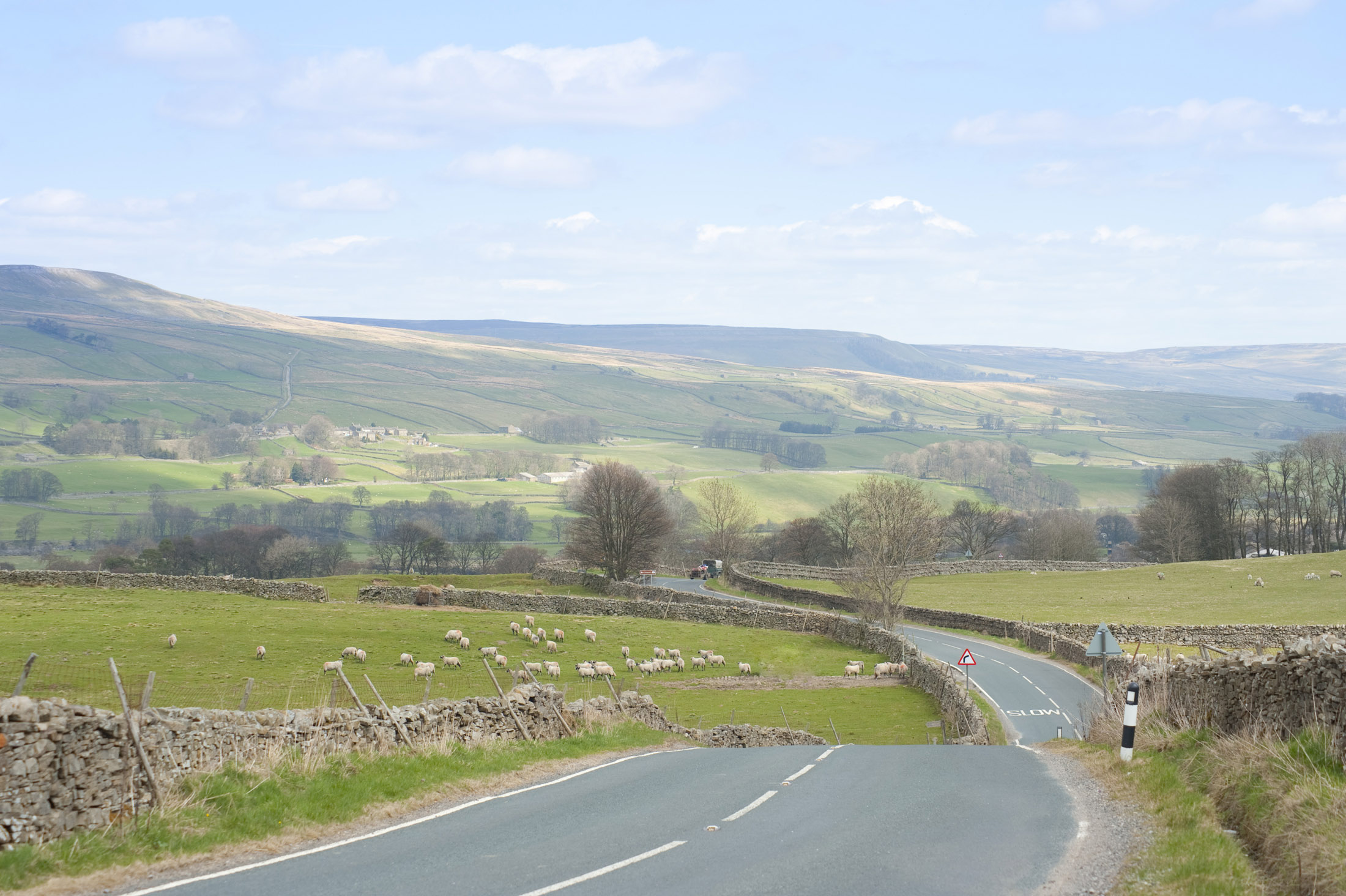 an image of winding country road snakes it's way through the yorkshire dales national park