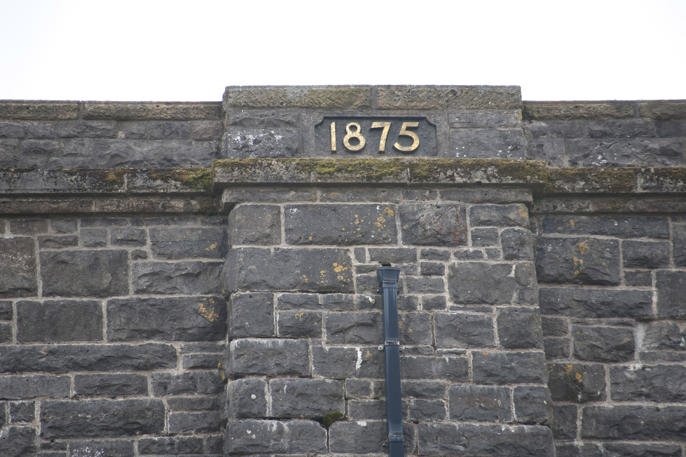an image of details of a memorial stone at the centre of the ribblehead viaduct marking the opening in 1875