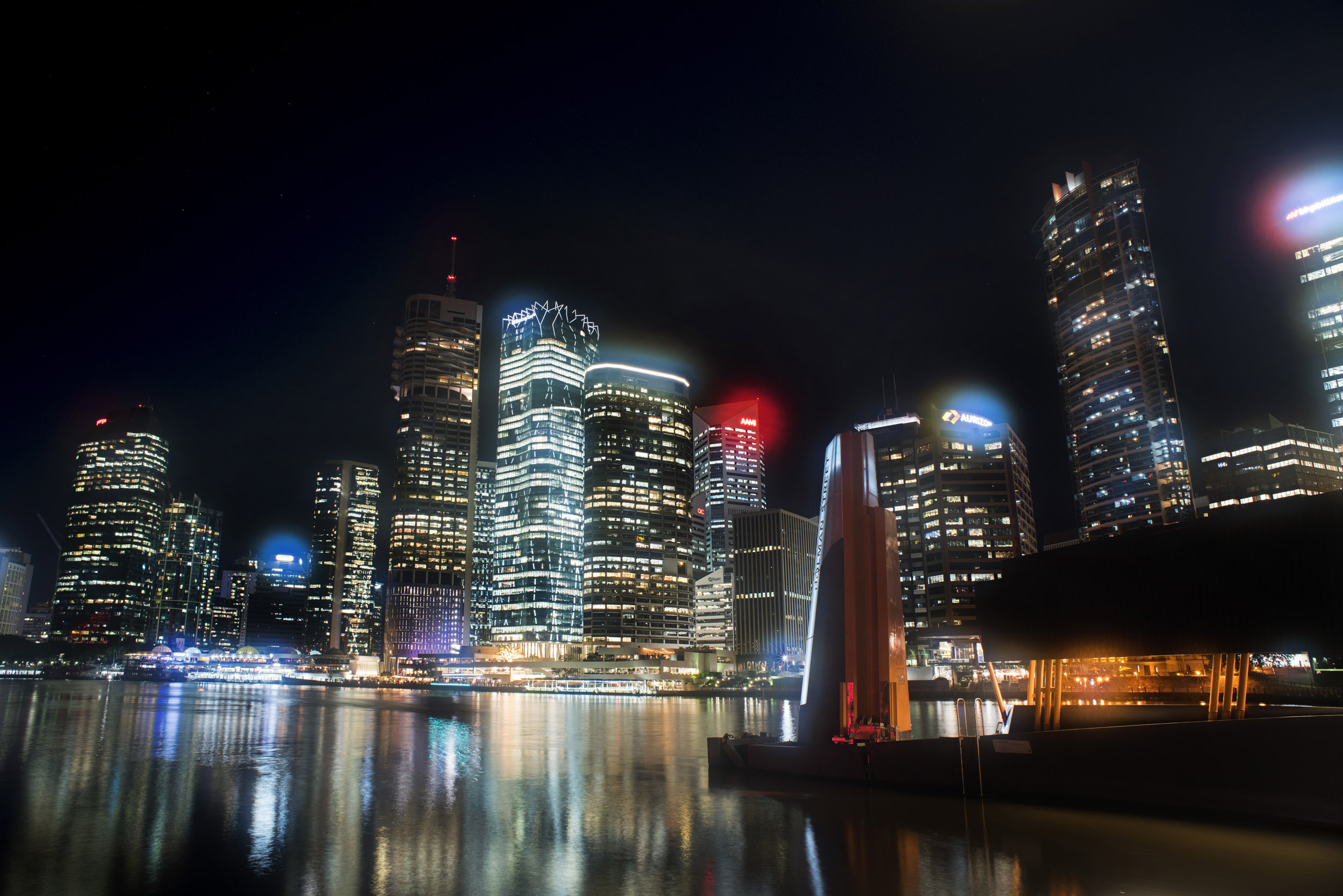 an image of Night cityscape with illuminated skyscrapers reflecting in water, Brisbane, Australia