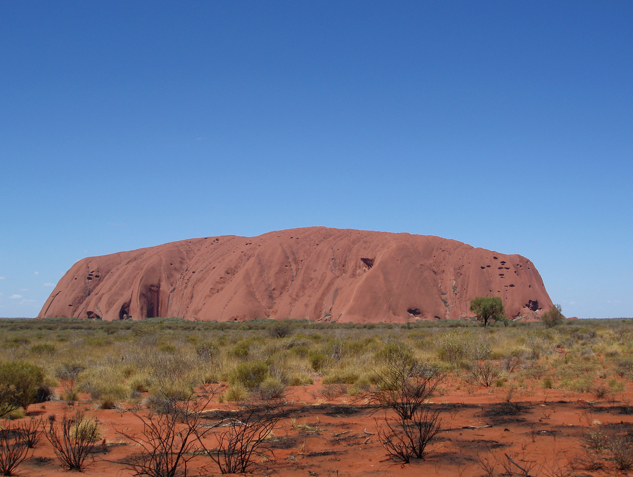 an image of Beautiful View of Famous Uluru Rock in Kata Tjuta National Park on Gradient Blue Sky Background.