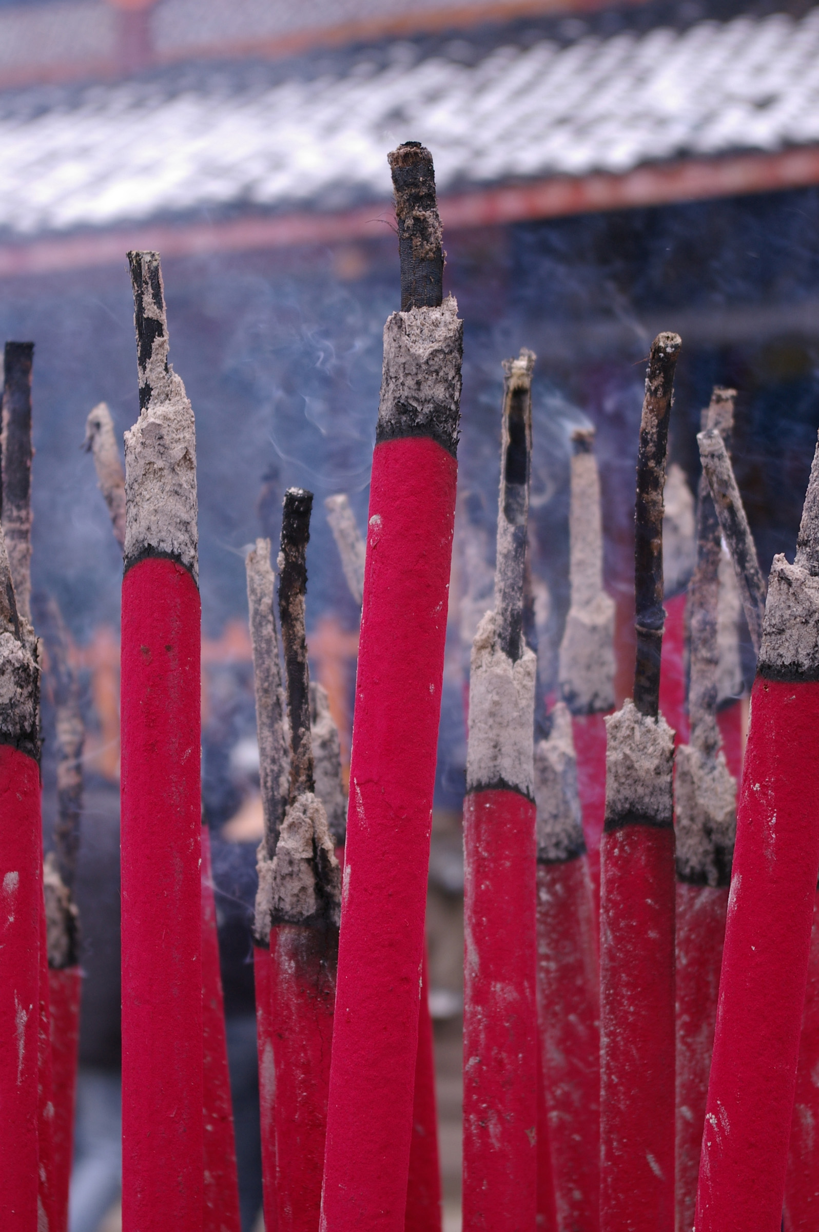 an image of Close up Burning Red Aromatic Traditional Incense Sticks at Chinese Temple