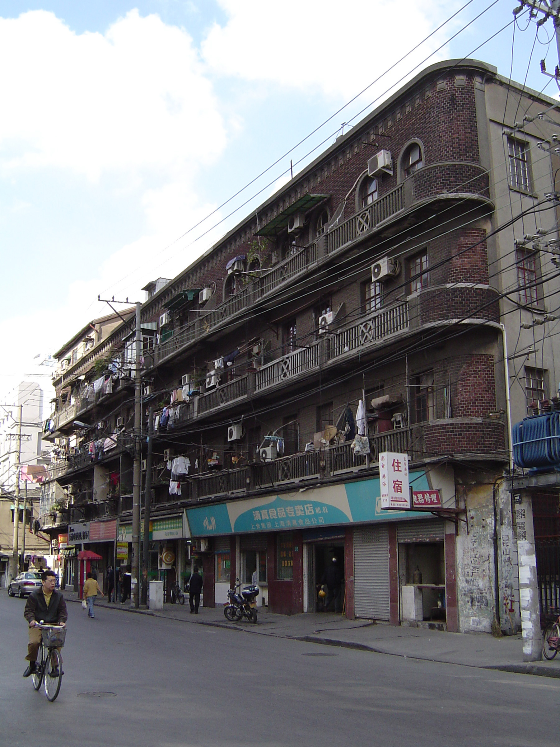 an image of Huge Vintage Building on Chinese Street Side, Captured with Bicycle Passing by