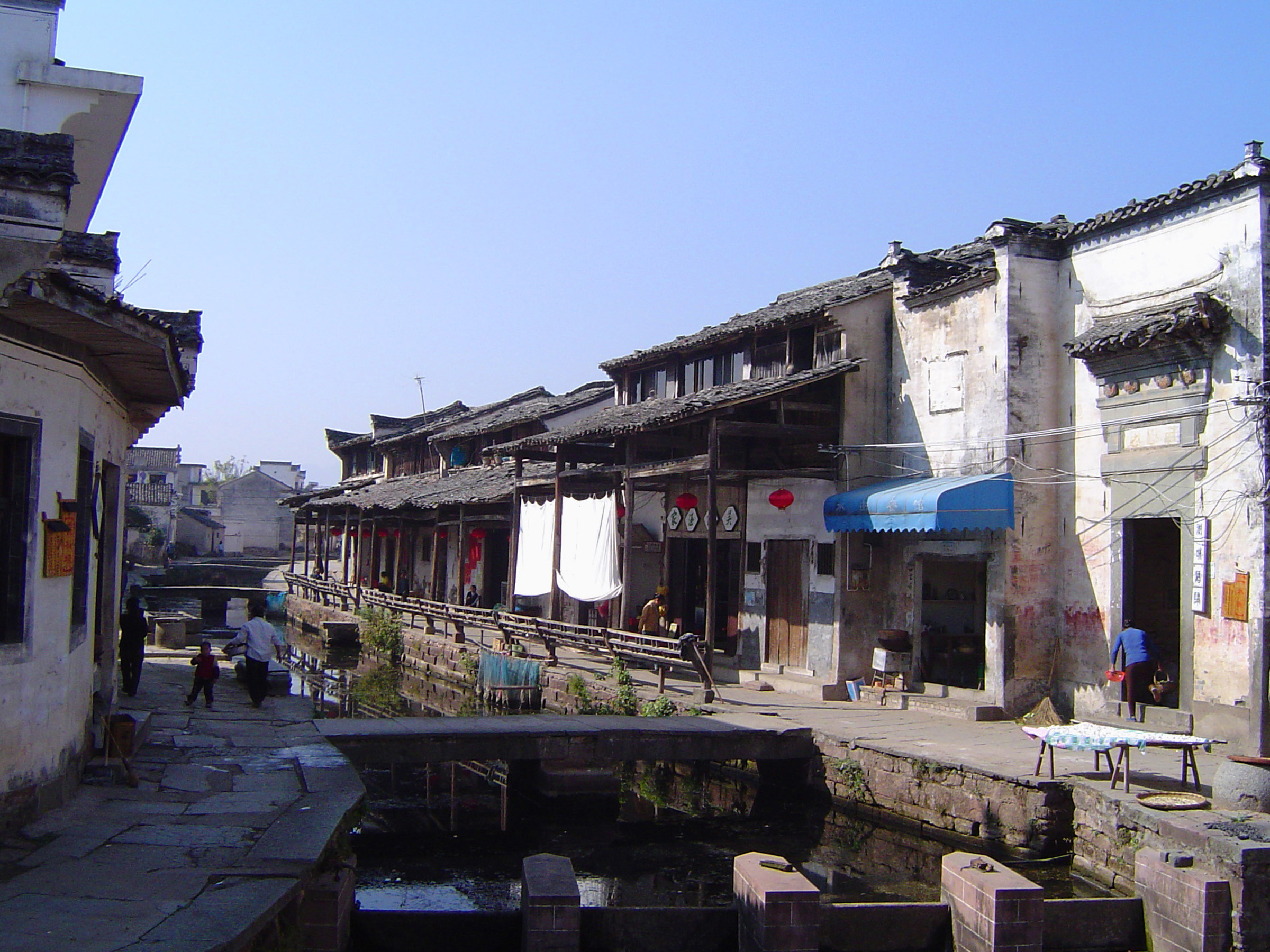 an image of Traditional Urban Streets with Building Structures Along the Canal Side in China