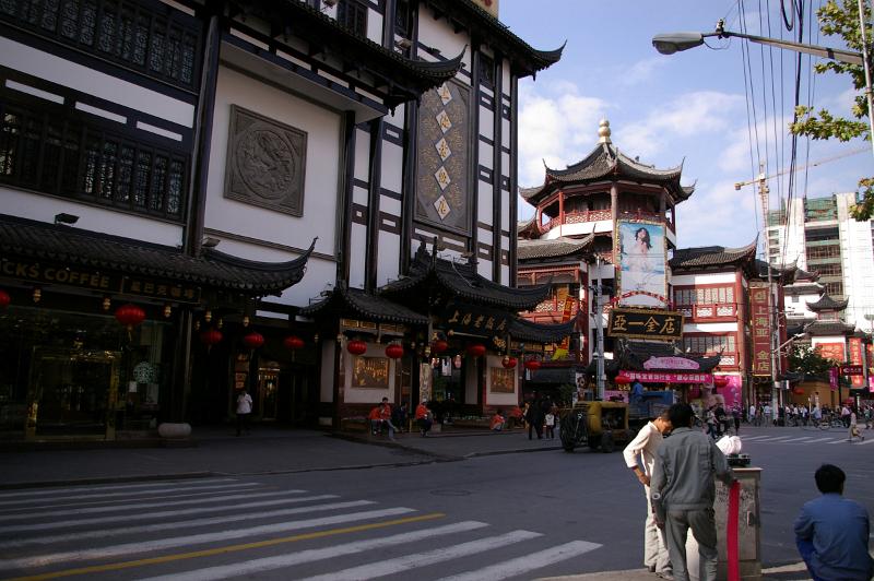 Architectural Huge Buildings at Chinese Urban Street with Busy Random People.