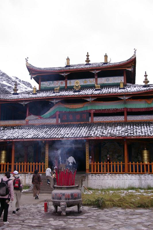 Burning Incense Sticks at the Entrance of Architectural Temple Building in China. Captured with Random Visitors Coming In.