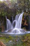 Beautiful Tourist Spot of Natural Waterfalls with Green Trees and Plants Above