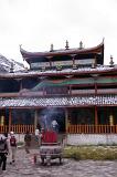 Burning Incense Sticks at the Entrance of Architectural Temple Building in China. Captured with Random Visitors Coming In.