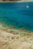 Yacht moored in a calm blue ocean off the Yasawa islands in Fiji, a popular tourist destination for tropical vacations