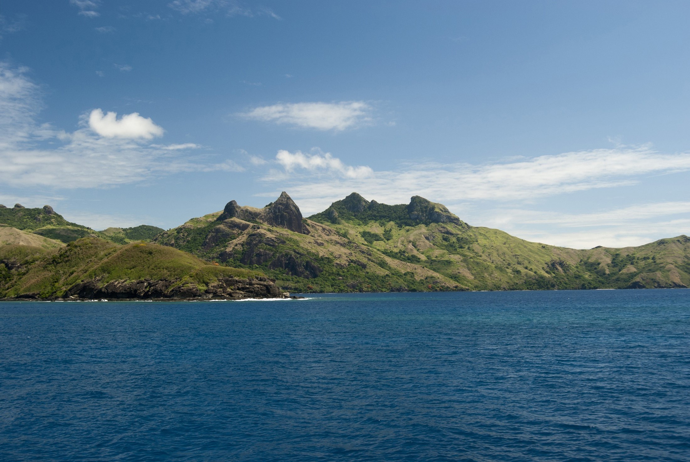 an image of Waya island, Fiji, is a popular tourist destination known for its beautiful beaches, traditional lifestyle and lush hillsides