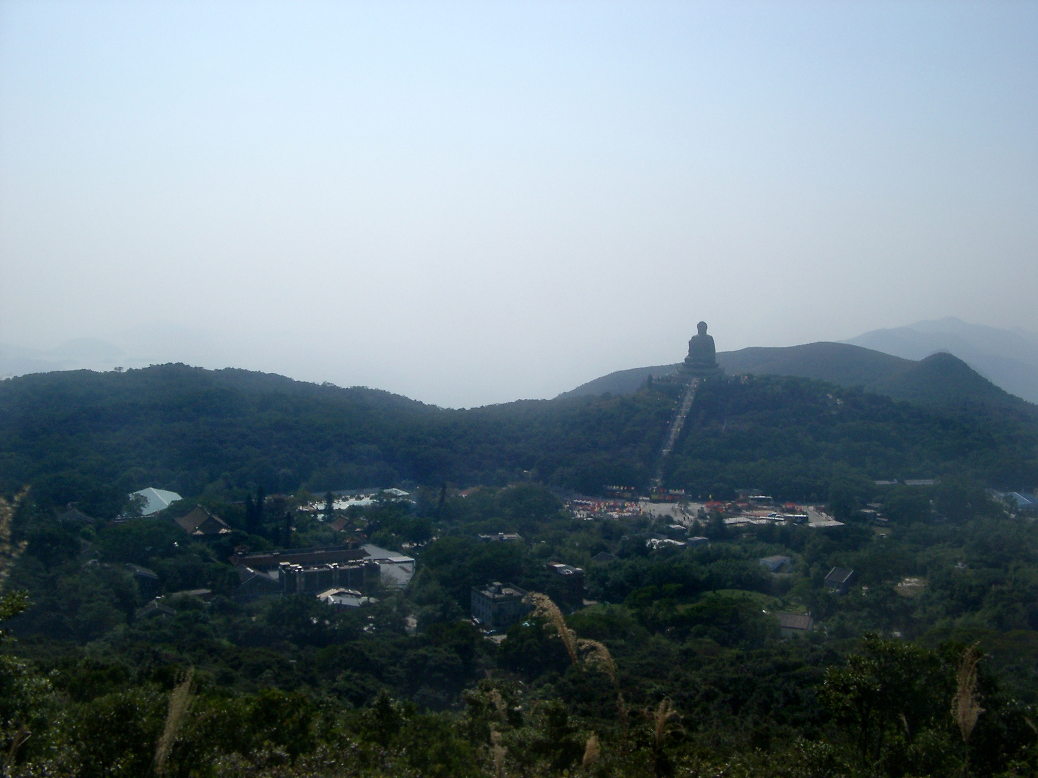 an image of Panorama Natural View in Hong Kong with Famous Vintage Big Buddha Structure on Hill Top.