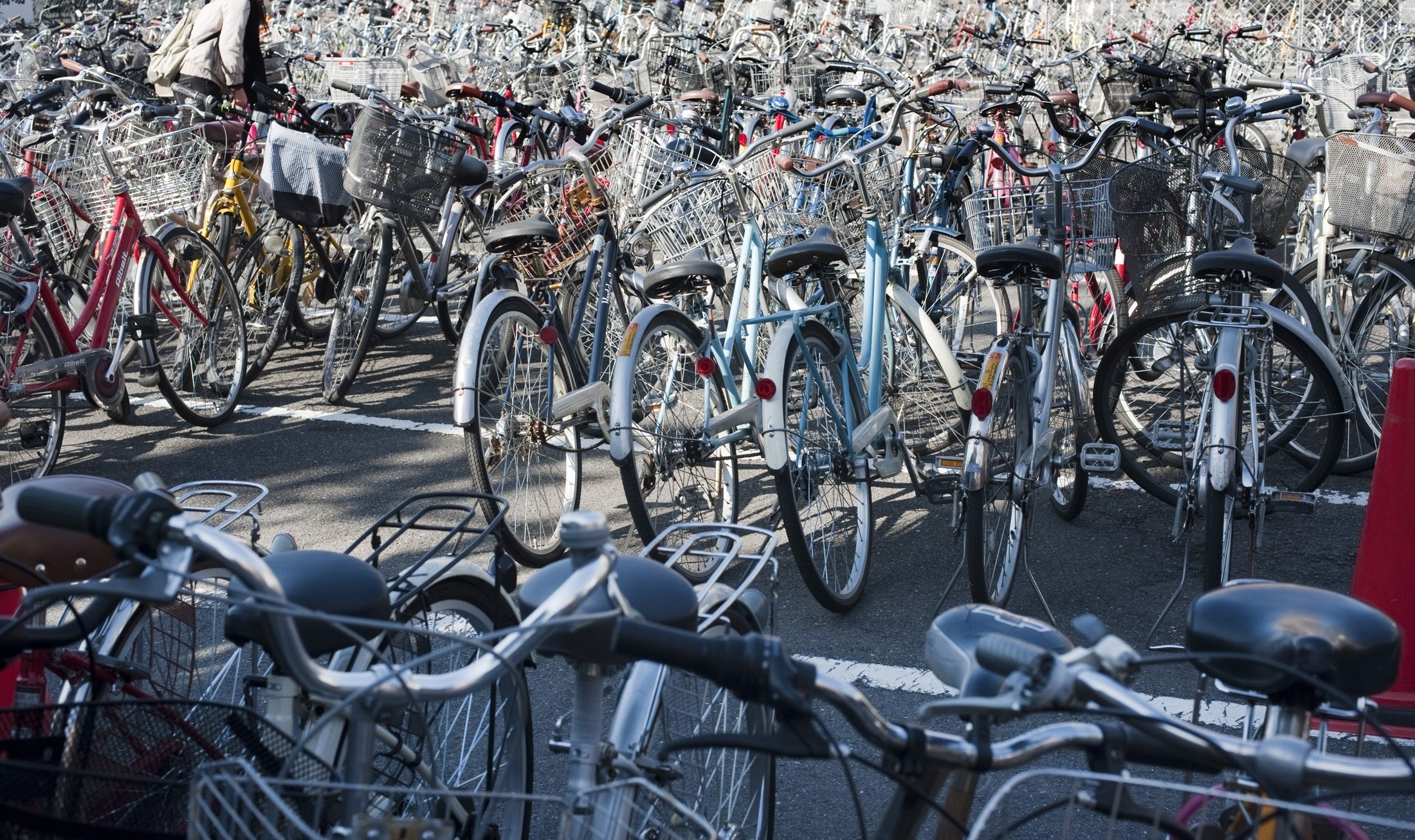 an image of Hundereds of bicycles parked in a Kyoto bicycle park