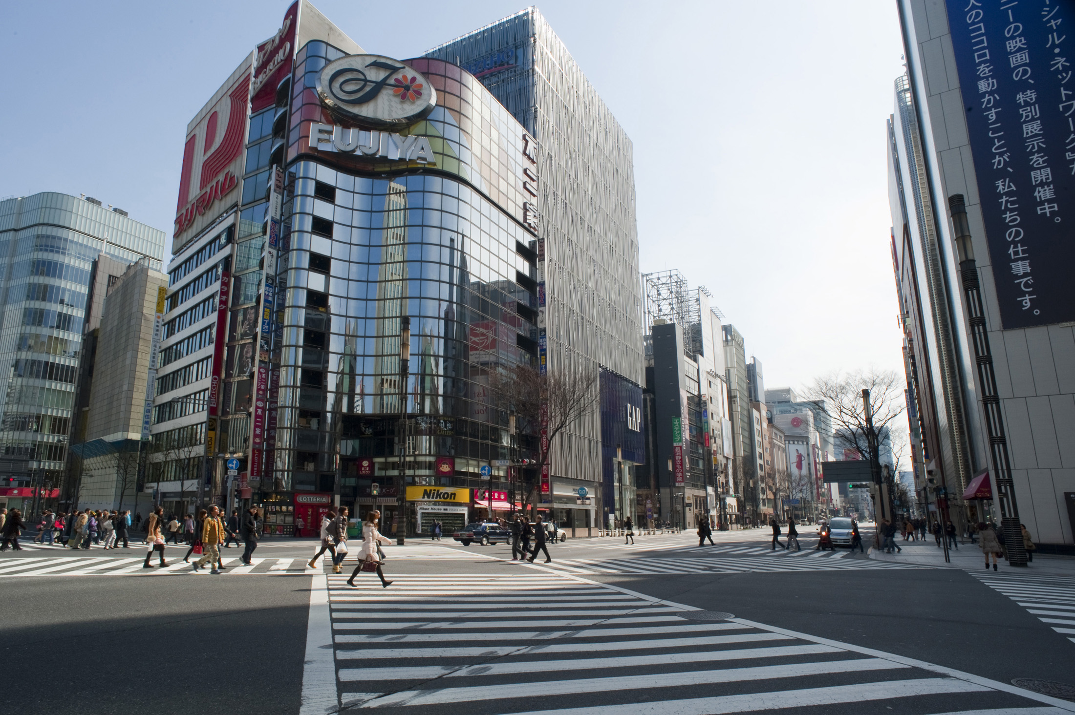 an image of pedestrians crossing the street in the ginza district of tokyo - not model released