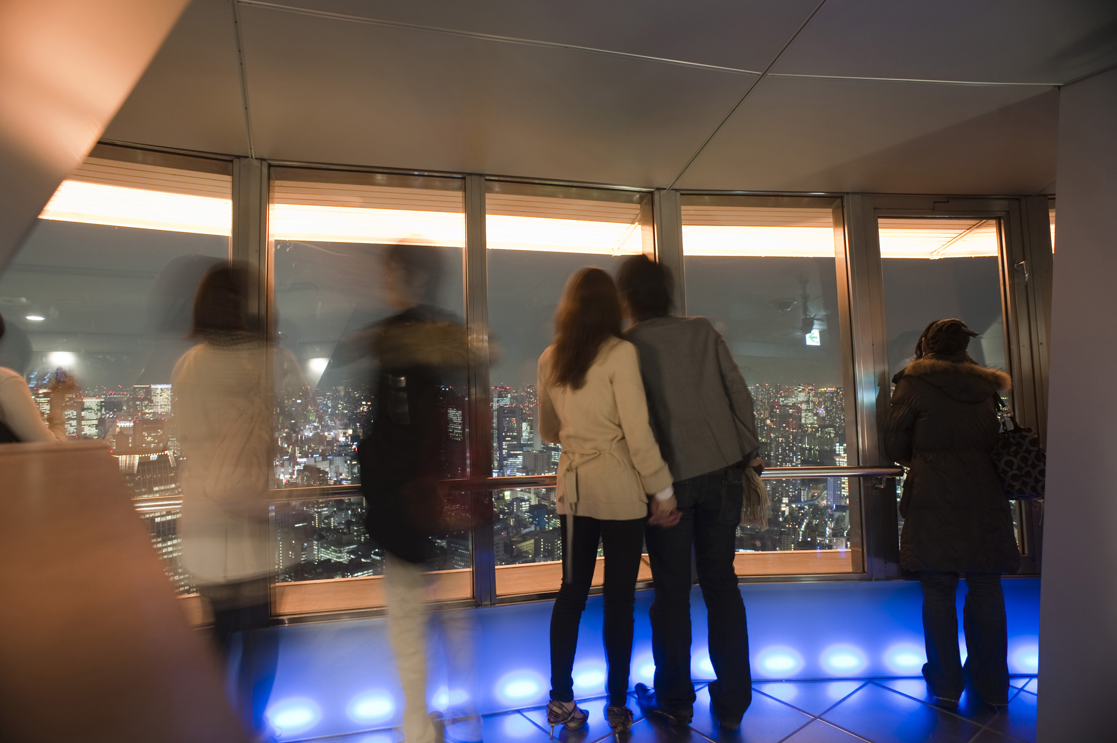 an image of visitors enjoying the view from the top of the tokyo tv tower at night  - not model released